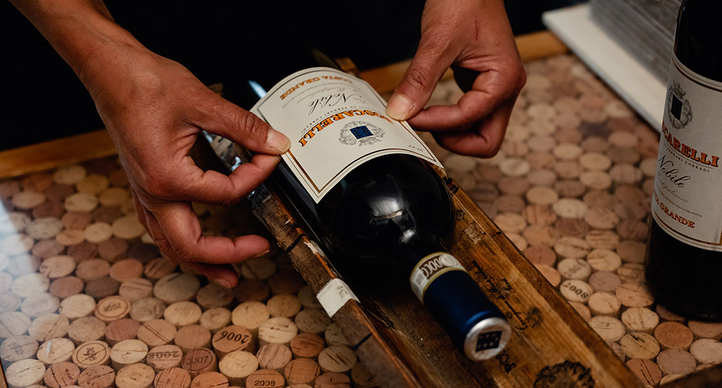 Aufkleben des Etiketts. Foto: Poderi Boscarelli